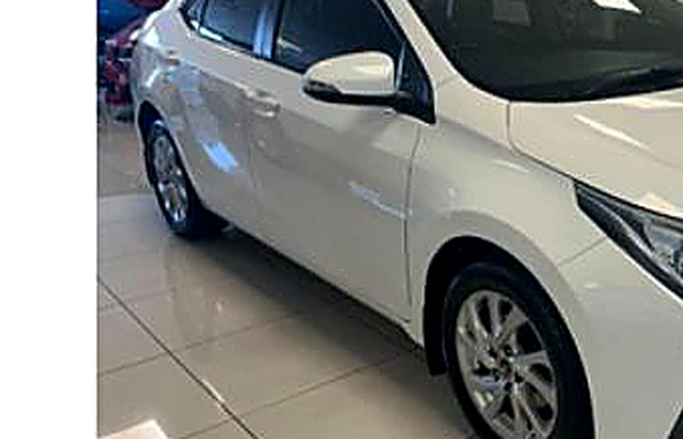 White economy sedan, front view